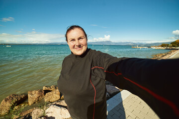 Active senior woman doing selfie outdoors, helthy lifestyle