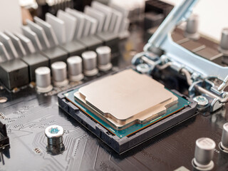 the process of connecting the CPU to the processor socket on a modern computer motherboard,...