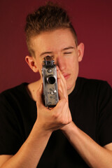 Young cinematographer with old, retro camera