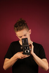 Fototapeta premium Young photographer with old, retro camera