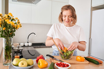 Woman preparing vegetable salad