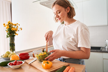 Woman is cutting ingredients on table