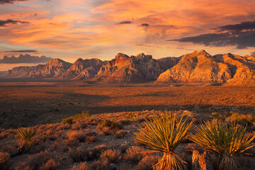 Orange first rays of dawn light on the cliffs of Red Rock Canyon National Conservation Area nea Las...