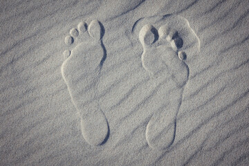 foot marks on a sand in Debki resort village on the Baltic Sea coast in Pomerania region of Poland