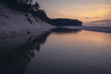 Evening view of River Piasnica mouth in Debki resort village on the Baltic Sea coast in Pomerania region of Poland