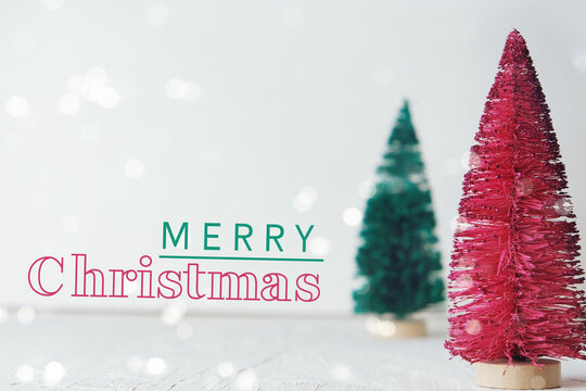 Pink And Green Christmas Trees On White Background For Winter Holiday Card.