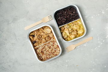 Takeout coronavirus food. Different aluminium lunch box with ravioli, curry chicken rice, gyoza tempura, noodles vegetables, lentils with pumpkin. covid-19 takeaway food delivery.	
