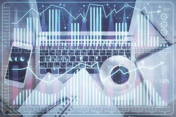 Stock market chart and top view computer on the table background. Double exposure. Concept of financial analysis.