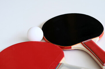Table tennis paddle and ball on white background.