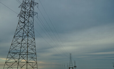 High voltage power lines over Lake Pontchartrain near New Orleans on an overcast evening.