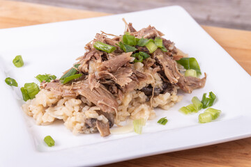 Gourmet mushroom risotto with duck meat on top