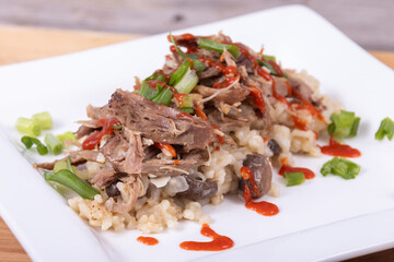 Gourmet mushroom risotto with duck meat on top