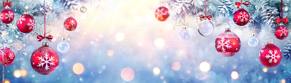 Canvas Prints christmas balls hanging fir branches with lights in abstract defocused background
