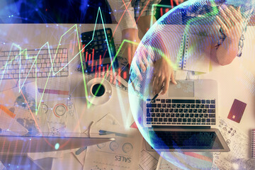 Double exposure of man and woman working together and financial graph hologram drawing. market analysis concept. Computer background. Top View.