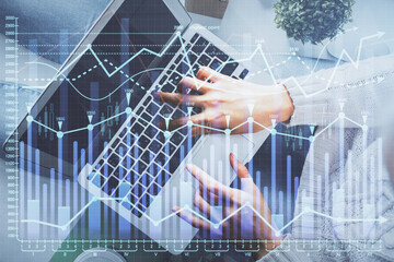 Double exposure of woman hands working on computer and forex chart hologram drawing. Top View. Financial analysis concept.