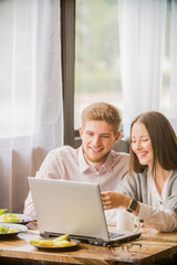 a beautiful girl and a guy communicate on the phone together,  remote communication on the Internet observing a social distance
