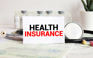 Torn paper with health insurance text. Health insurance concept