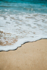 Soft blue ocean wave on sandy beach. Background.
