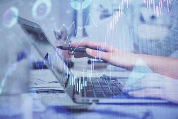 Multi exposure of woman hands typing on computer and financial graph hologram drawing. Stock market analysis concept.