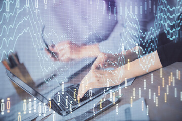 Multi exposure of woman hands typing on computer and financial chart hologram drawing. Stock market analysis concept.