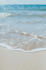 Soft blue ocean wave on sandy beach. Background.