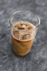 cold brew iced vanilla latte coffee in tall glass with ice