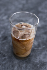 cold brew iced vanilla latte coffee in tall glass with ice