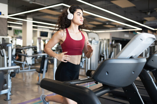 Pretty latin young woman going on a run at the gym