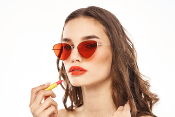 Fashionable brunette in sunglasses with makeup lipstick model