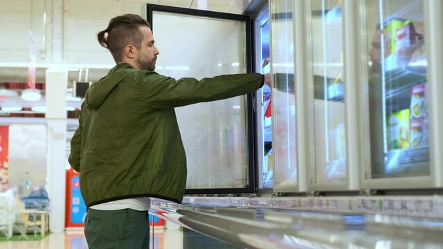 Man buying frozen food in the supermarket