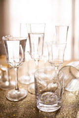 Several champagne glasses over gold christmas background. Celebrating new year concept.