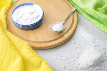 white cream and sea salt on a wooden board with towels.