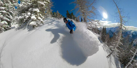 SELFIE: Cool shot of guy on winter vacation snowboarding on a perfect sunny day.
