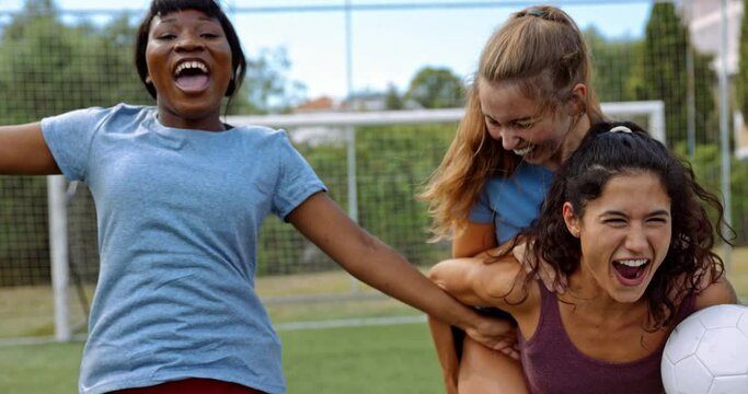 Teenager group of friends celebrating scored goal during soccer practice
