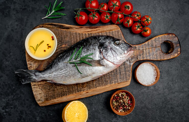  Raw dorado fish with spices on a stone background