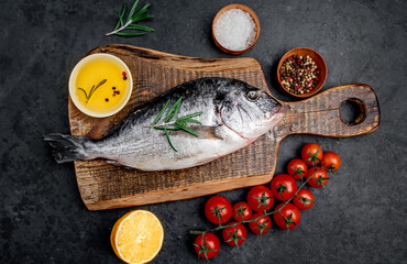  Raw dorado fish with spices on a stone background