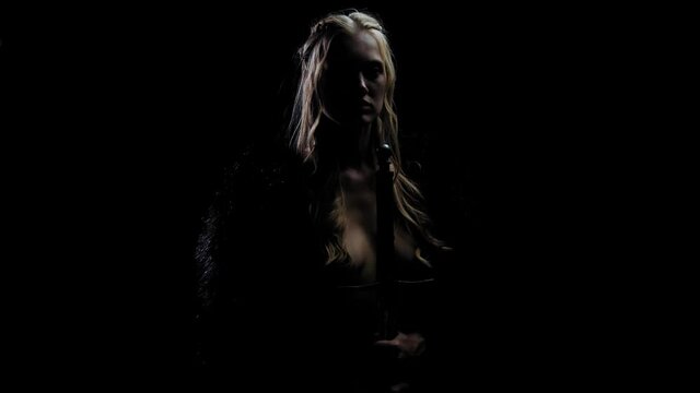 Medieval warrior woman with a sword is standing in the dark, viking, blonde, 4k
