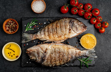 grilled dorado fish with spices on a stone background