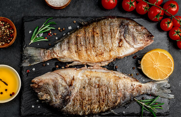 grilled dorado fish with spices on a stone background