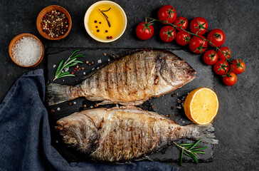 grilled dorado fish with spices on a stone background