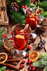 Fototapeta na wymiar mulled wine with orange and cranberries for Christmas
