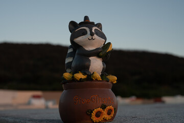 Raccoon statue with sunrise or sunset at golden hour