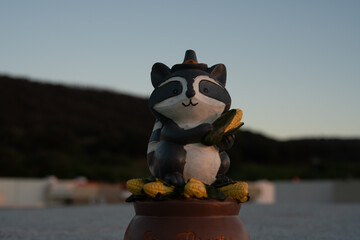 Raccoon statue with sunrise or sunset at golden hour
