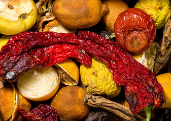 Mix of spoiled fruits and vegetables, close-up. Food waste problem concept.