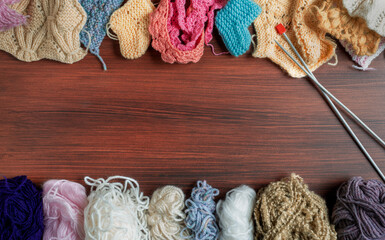 Hand-knitted things and knitting yarns with a pair of knitting needles. Copy space.