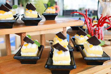 Slice of delicious vanilla cake on wooden table.