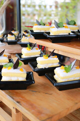 Slice of delicious vanilla cake on wooden table.