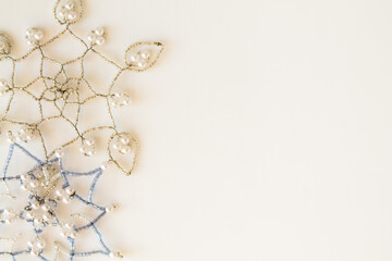 Obraz na płótnie Canvas Snowflakes made of beads on a white background. Christmas background. Christmas mood.