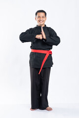 Obraz na płótnie Canvas men standing and smiling wearing pencak silat uniforms stand up with respectful hand movements on the isolated background