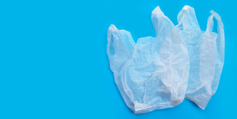 Fototapeta premium White plastic bags on blue background. Copy space